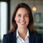 Portrait of a professional financial advisor, female, with a friendly and approachable expression, in a modern business environment.